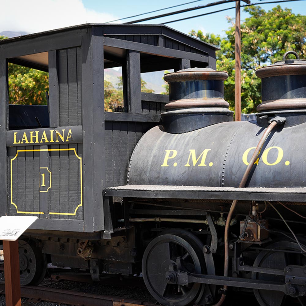 image of historic smokestack and trains in Lahaina.